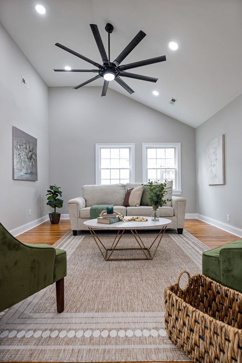 Ceiling fan being assembled beneath a verified mounting bracket using its specified components