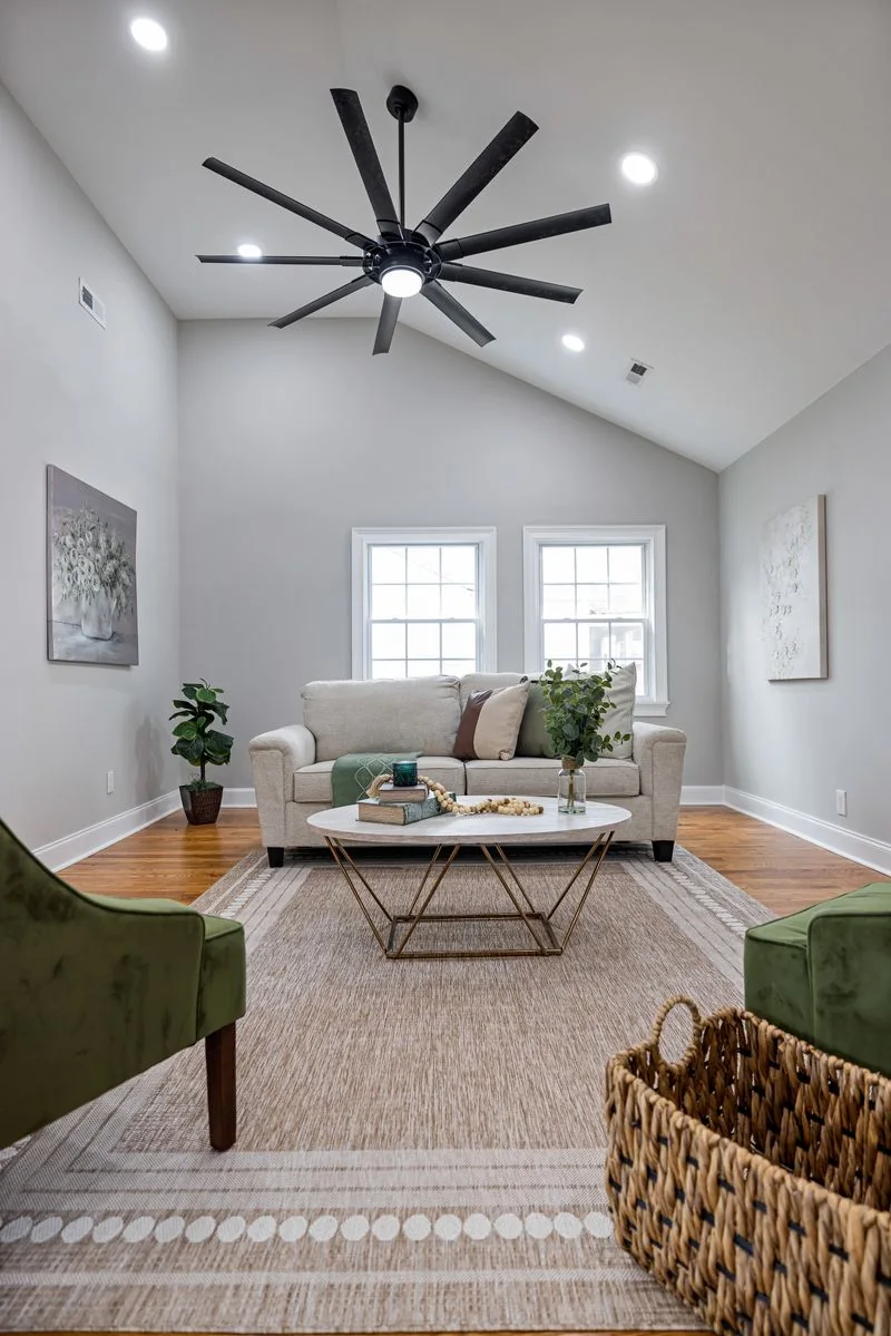 Ceiling fan and natural textures in a thoughtfully furnished living room