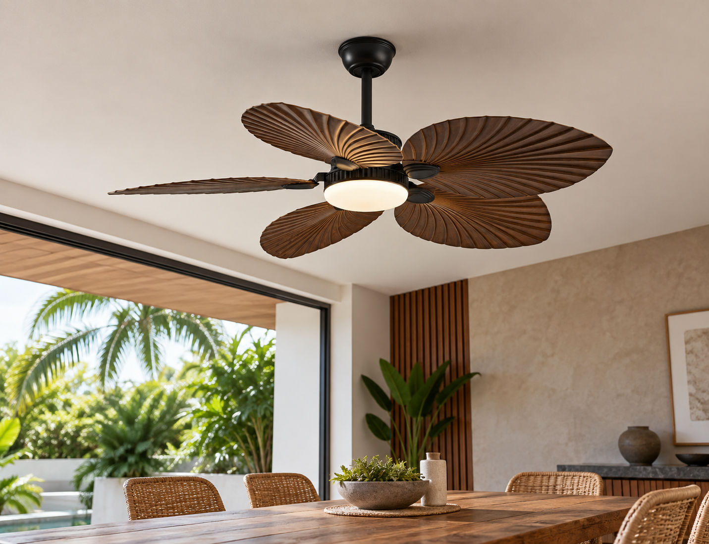 Tropical leaf ceiling fan with light above a modern dining area